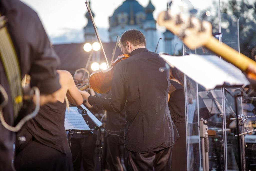 Male musician playing violin at outdoor concert
