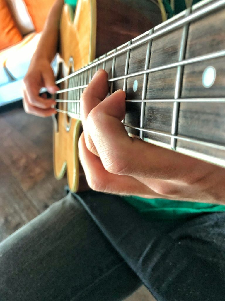 Music student practicing the bass guitar